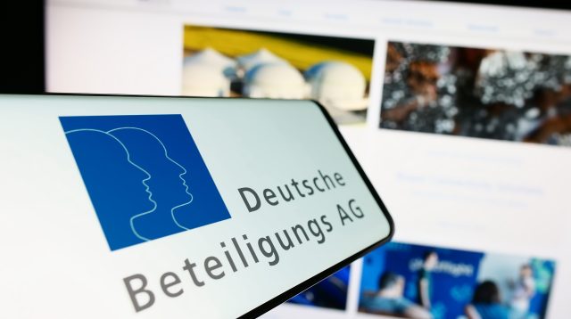 Ein Mobiltelefon mit dem Logo der Deutschen Beteiligungs AG (DBAG) auf dem Bildschirm vor einer Website mit Fokus auf die Mitte des Telefondisplays